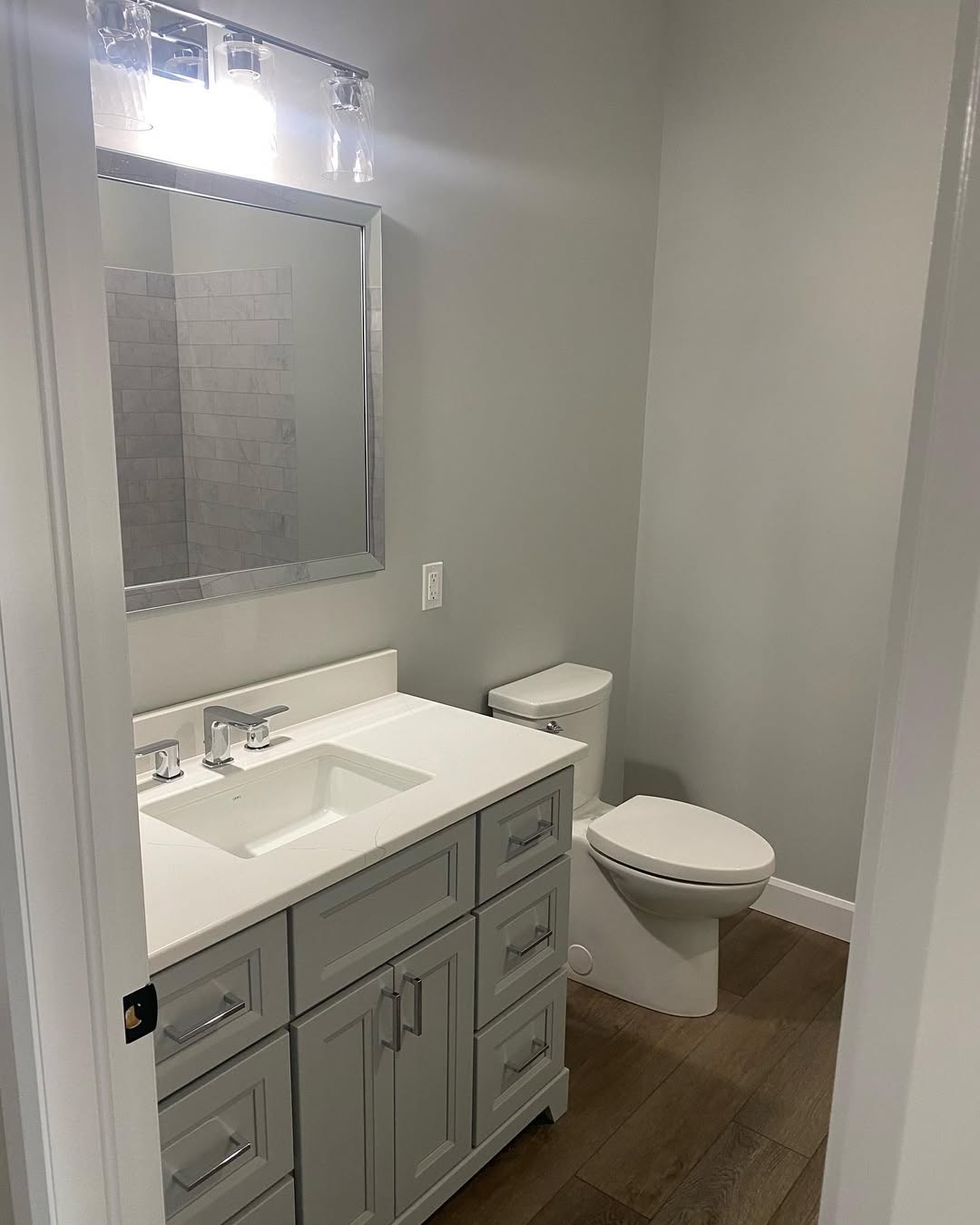 Bathroom with vanity and mirror. Shower in reflection
