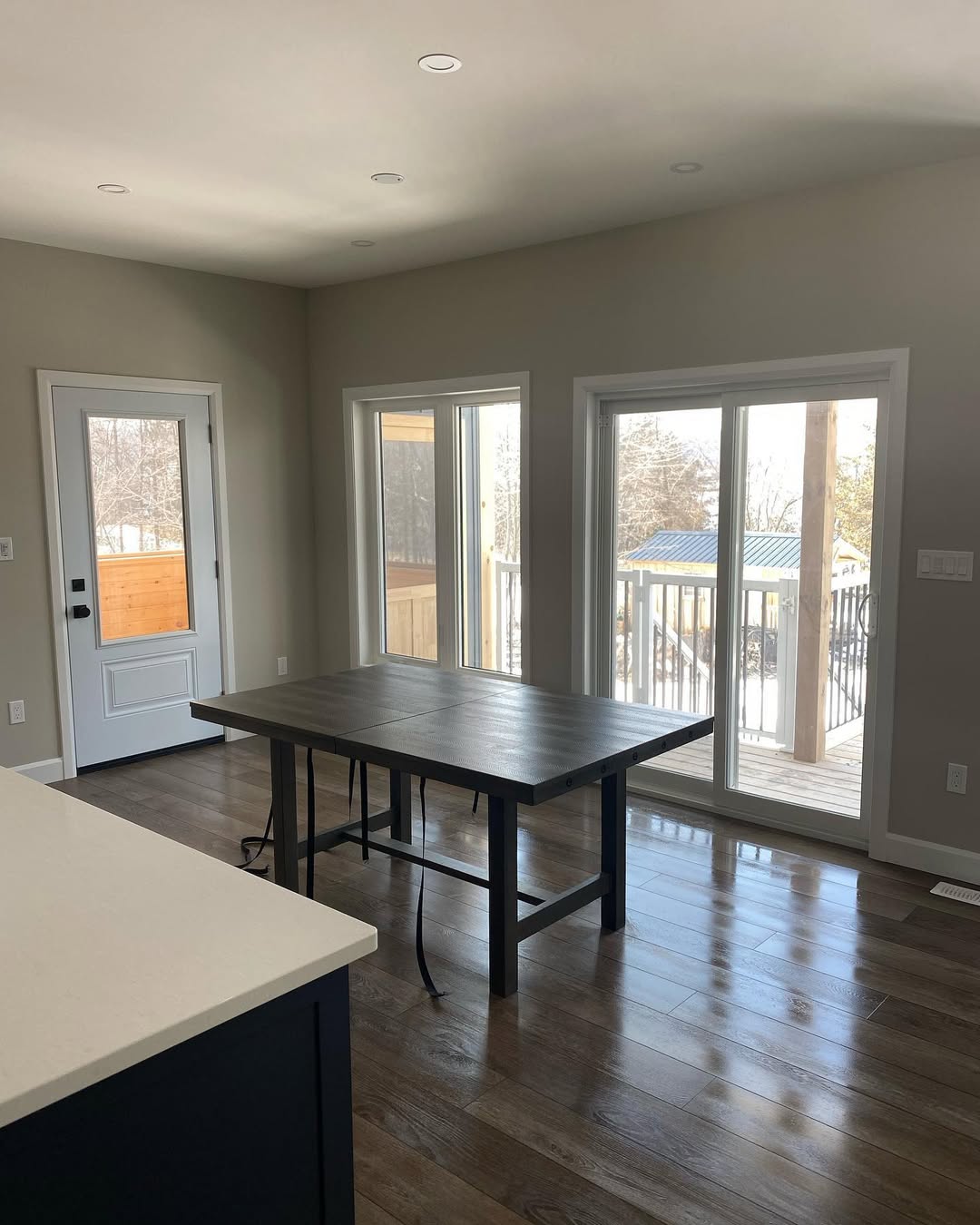 Dining table with windows and sliding doors leading to porch