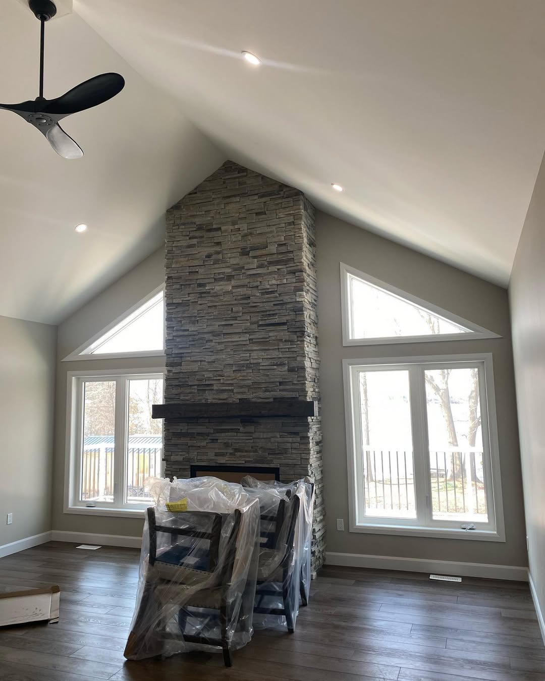 Large fireplace with floor to ceiling windows 