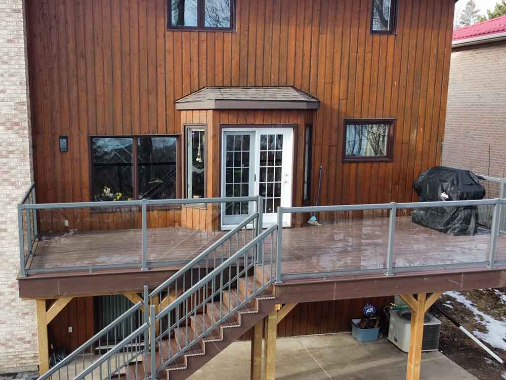 Second storey deck after transformation. New railings, stairs and deck boards