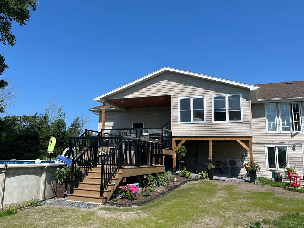 Sunroom addition with new deck leading to pool