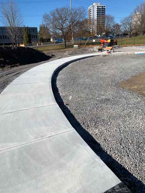 Curved sidewalk being installed for the Corrections Canada monument