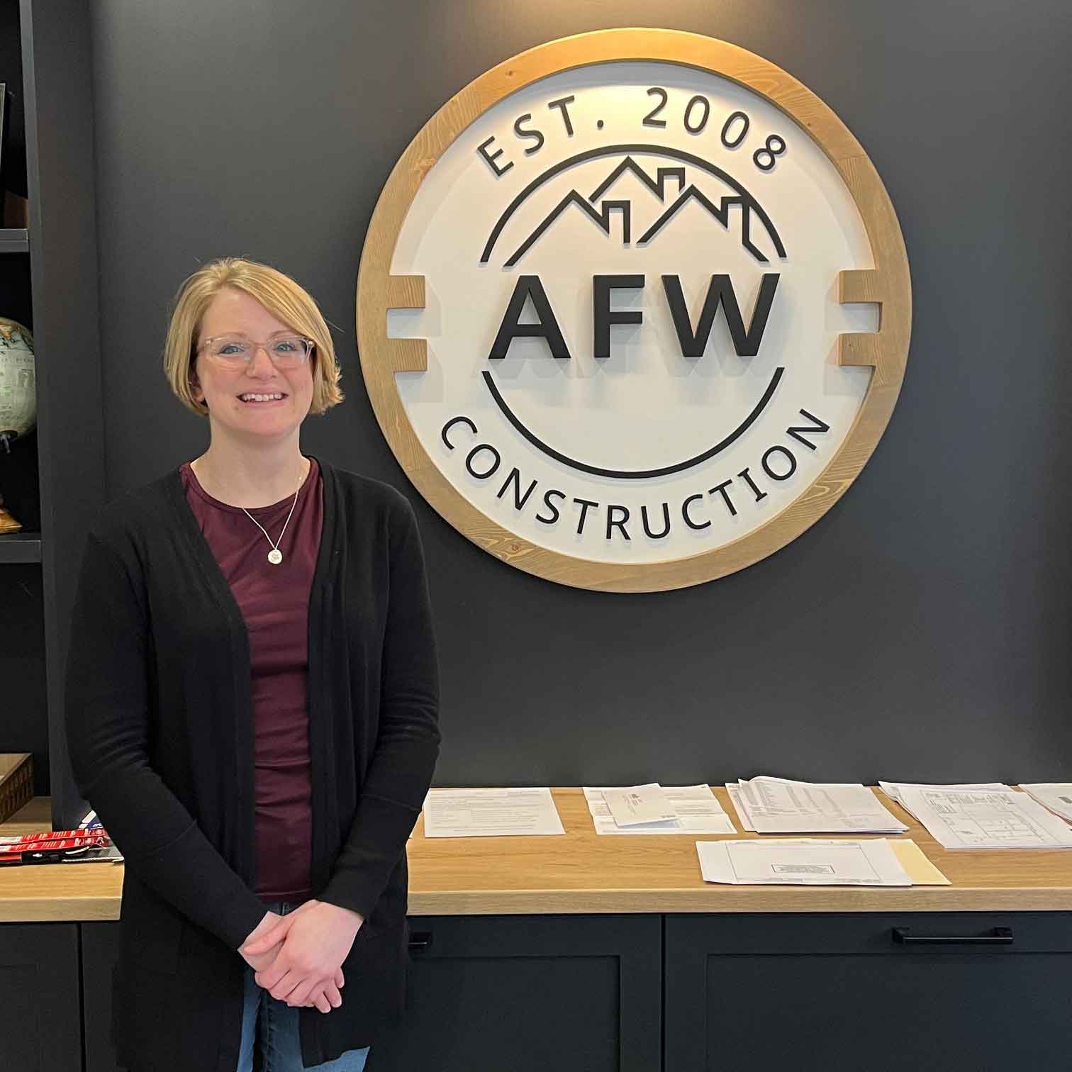 Michelle standing in front of AFW office signage